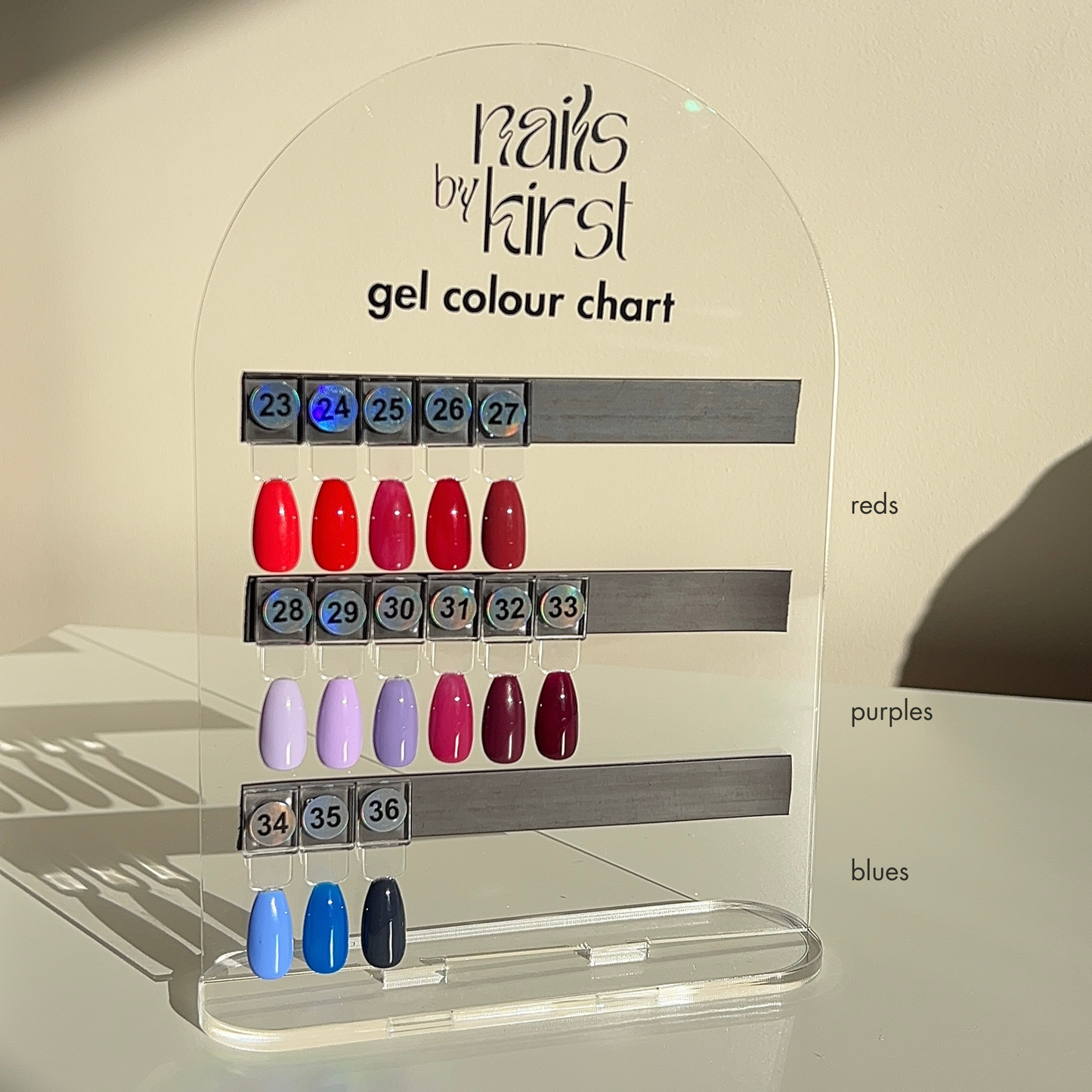 Nails by Kirst gel color chart with various red, purple and blue gel polish swatches