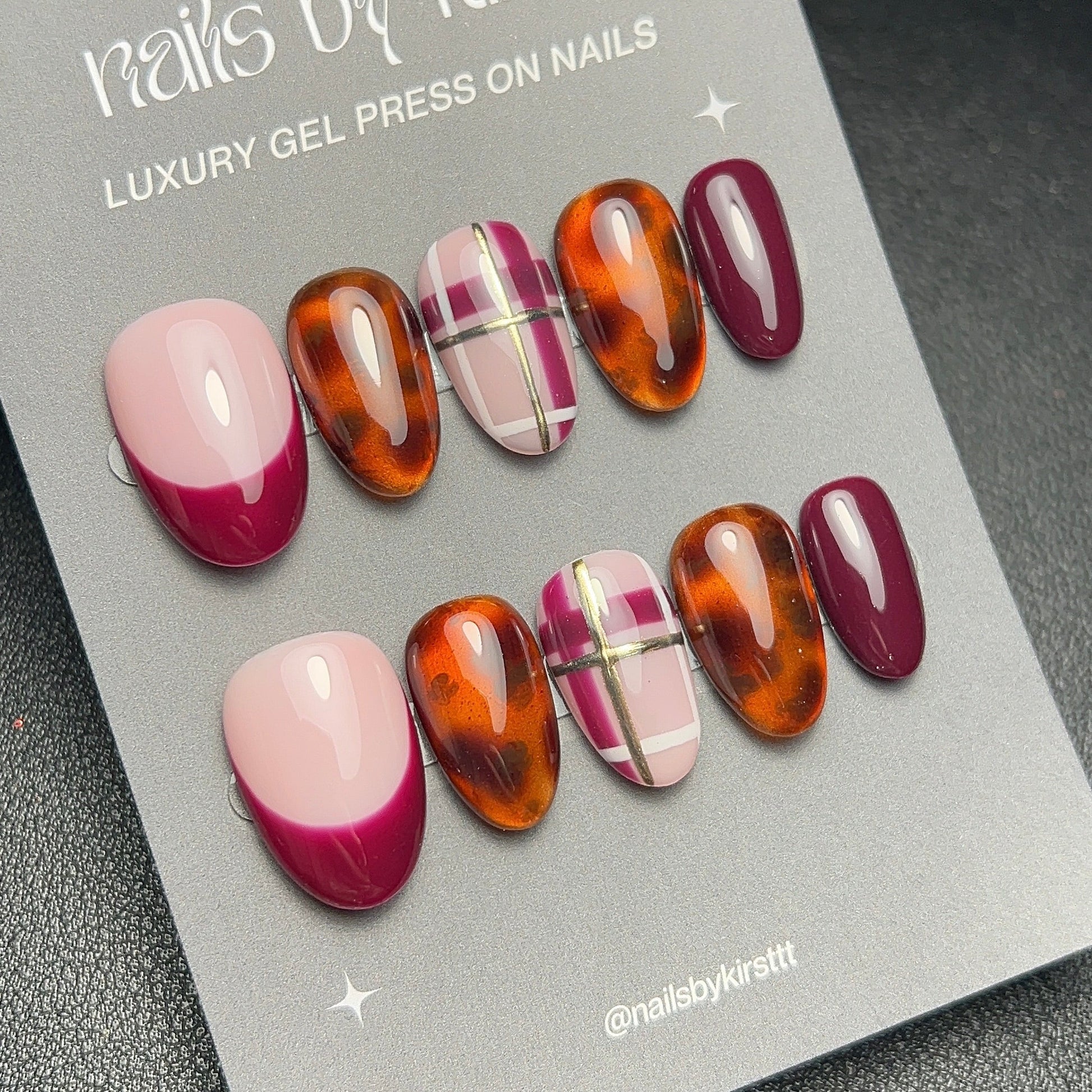Luxury gel press on nails with pink and brown gradient design on a branded card.