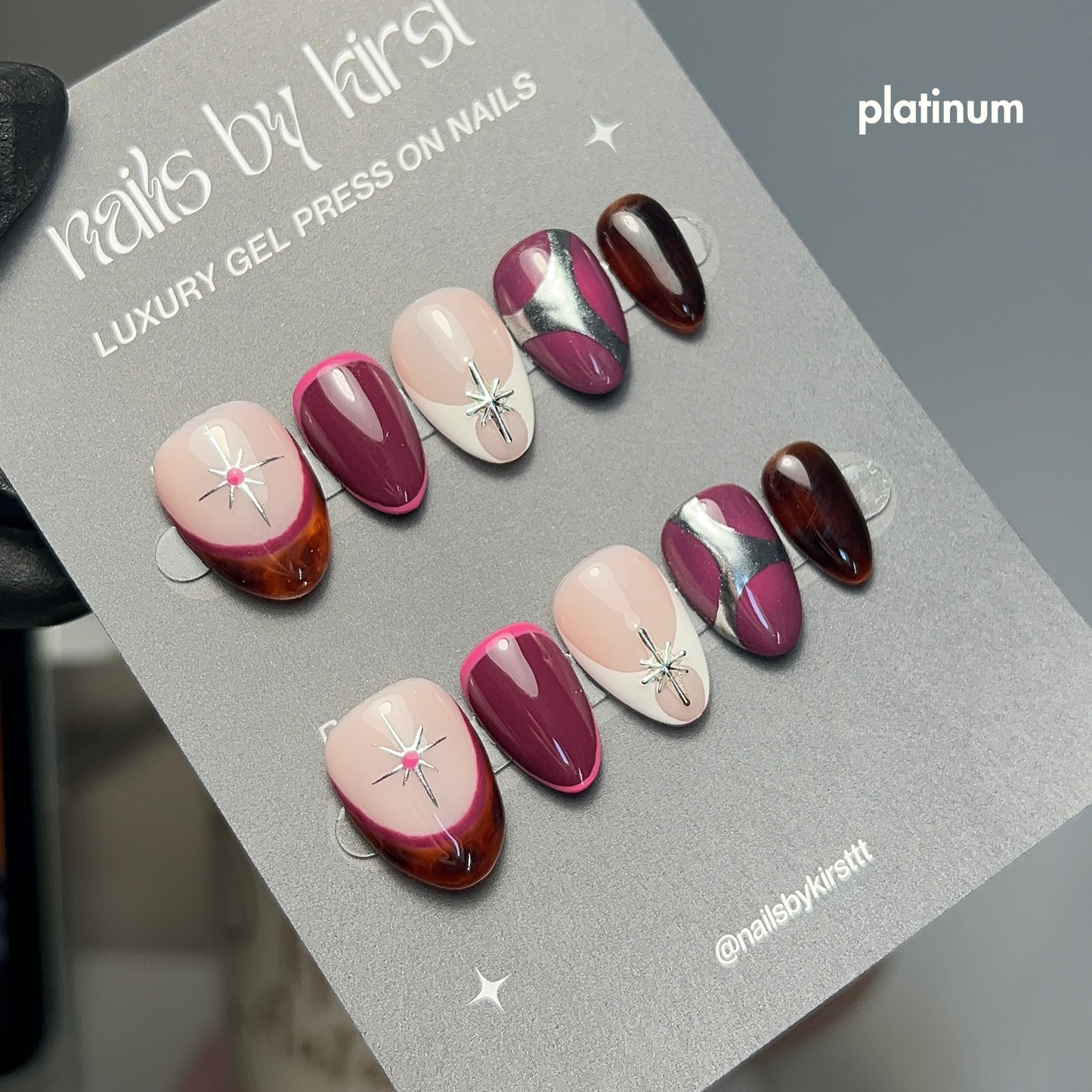 Set of gel press on nails with an autumnal design on a branded 'nails by kirsttt' card.