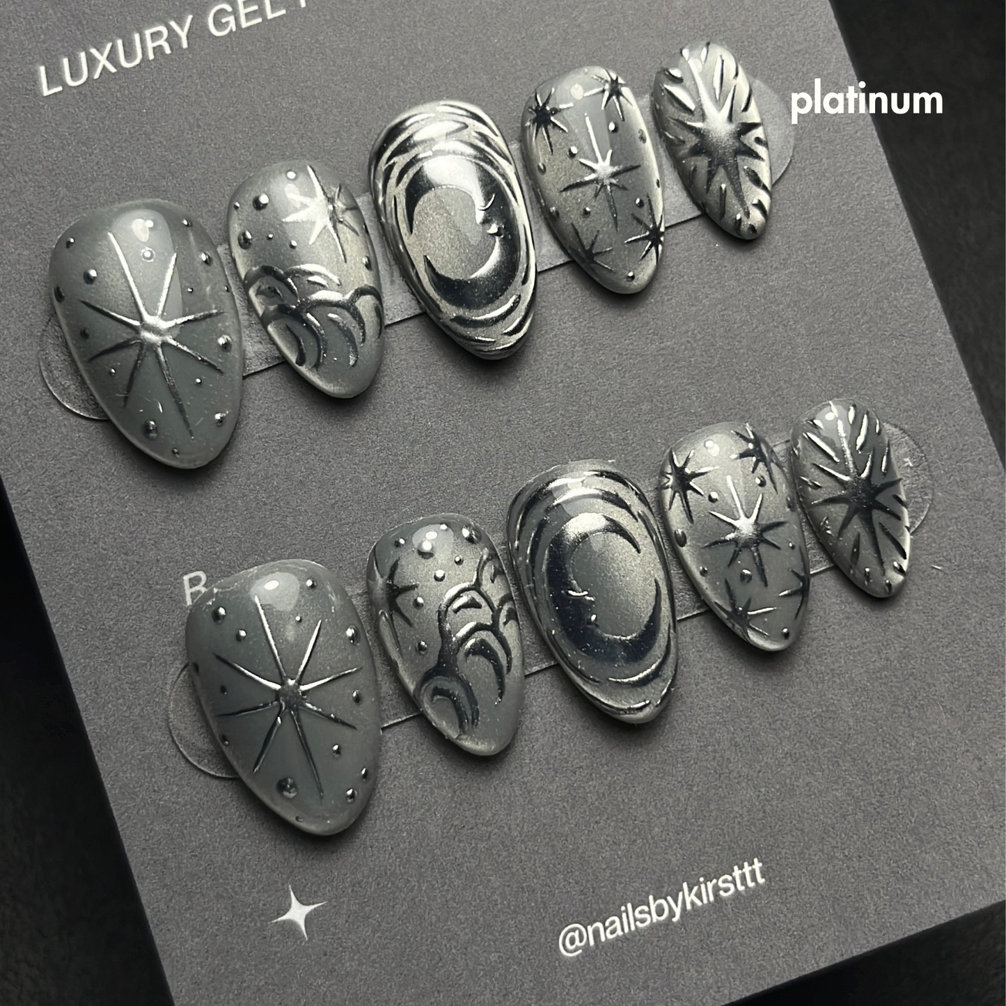 silver cat eye press on nails with chrome nail art design, listed as an example of a platinum tier custom nail set