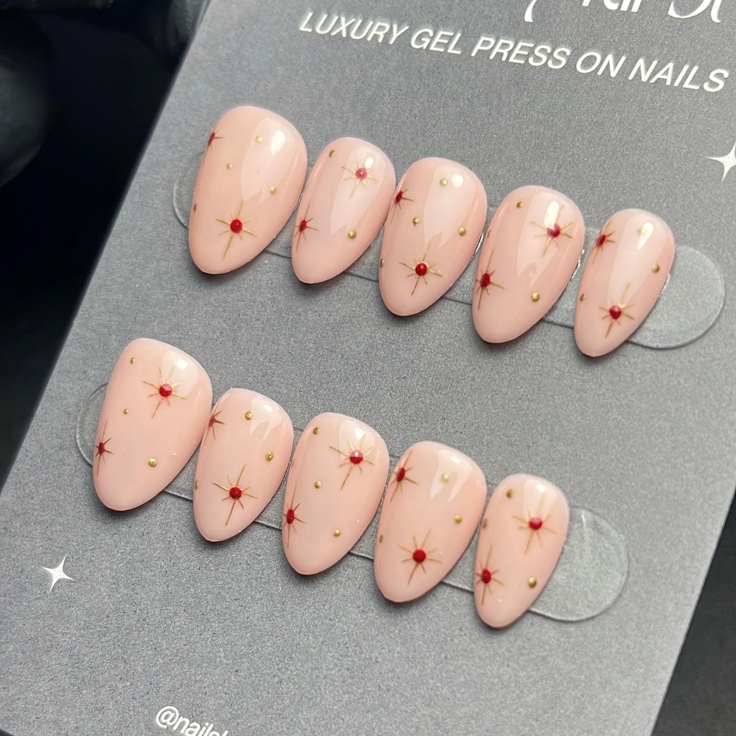 Set of press-on nails with red dots on a gray card with 'nails by kirst' branding.